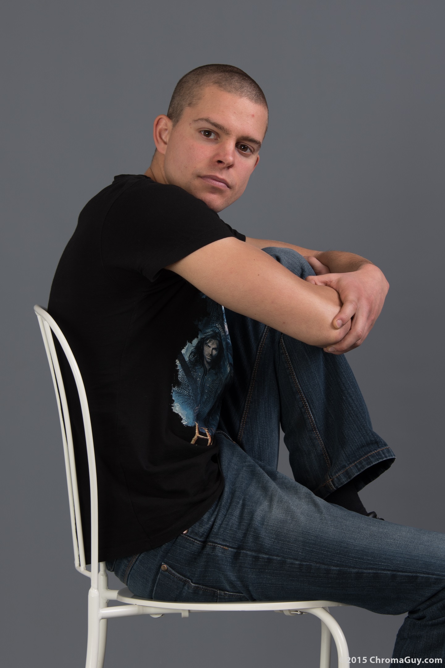 Guy sitting with one foot up on chair